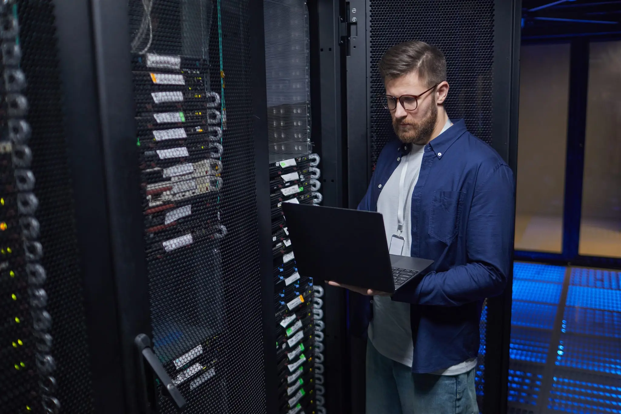 IT specialist checking network equipment in a server room